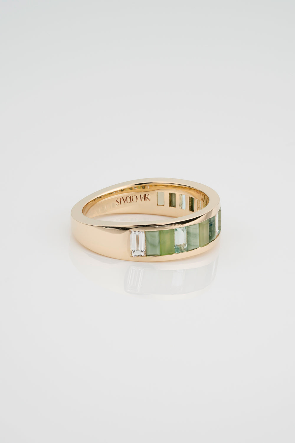 Custom Channel Set Band with North South Facing Baguettes made from Jasper, Jade, Green Beryl, and White Diamond. The back half of the band has a gold tapered backing.