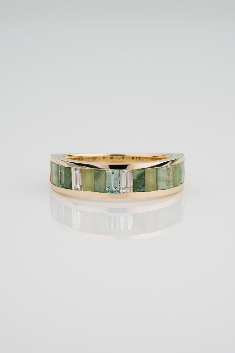 Custom Channel Set Band with North South Facing Baguettes made from Jasper, Jade, Green Beryl, and White Diamond. The back half of the band has a gold tapered backing.