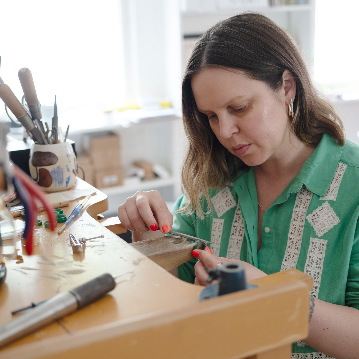 Erica shaping a wax band that will be used as a mold to cast the final ring band