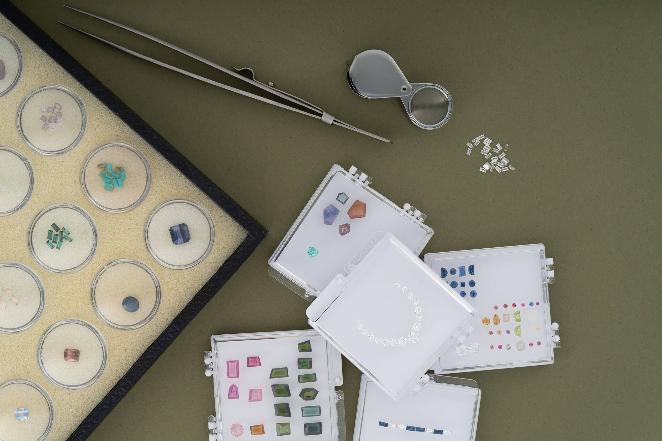 A display of stones and crafting tools arranged neatly on a table surface.