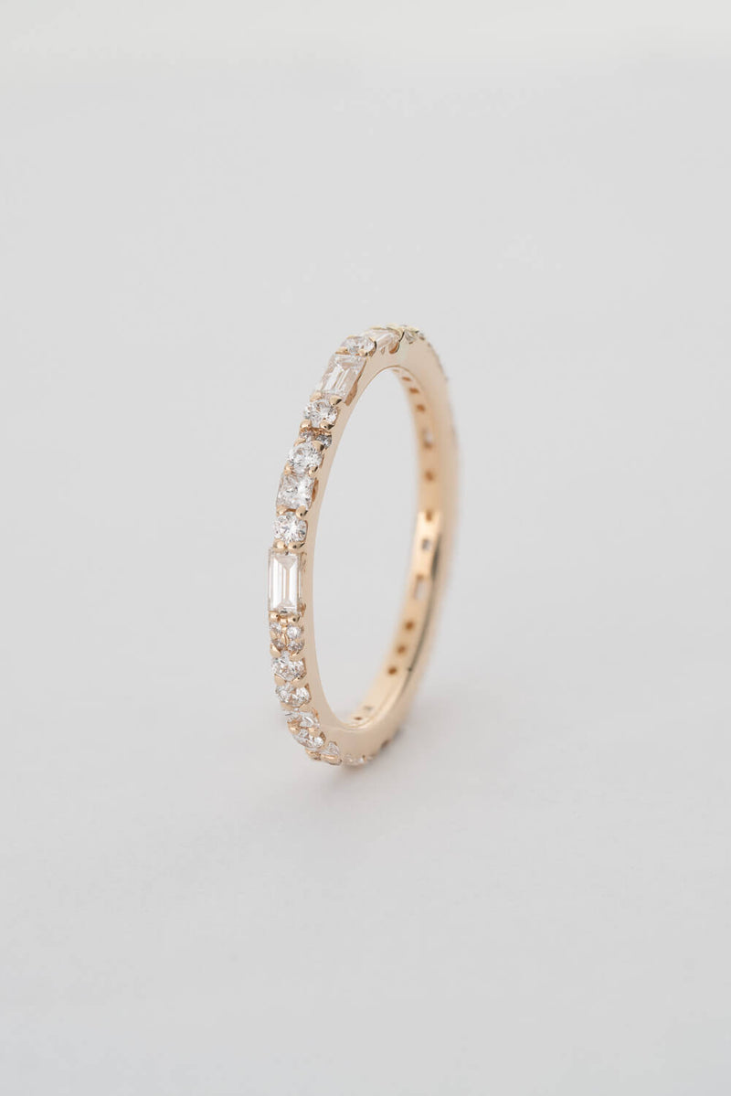A gold band inlaid with white diamonds in various cuts