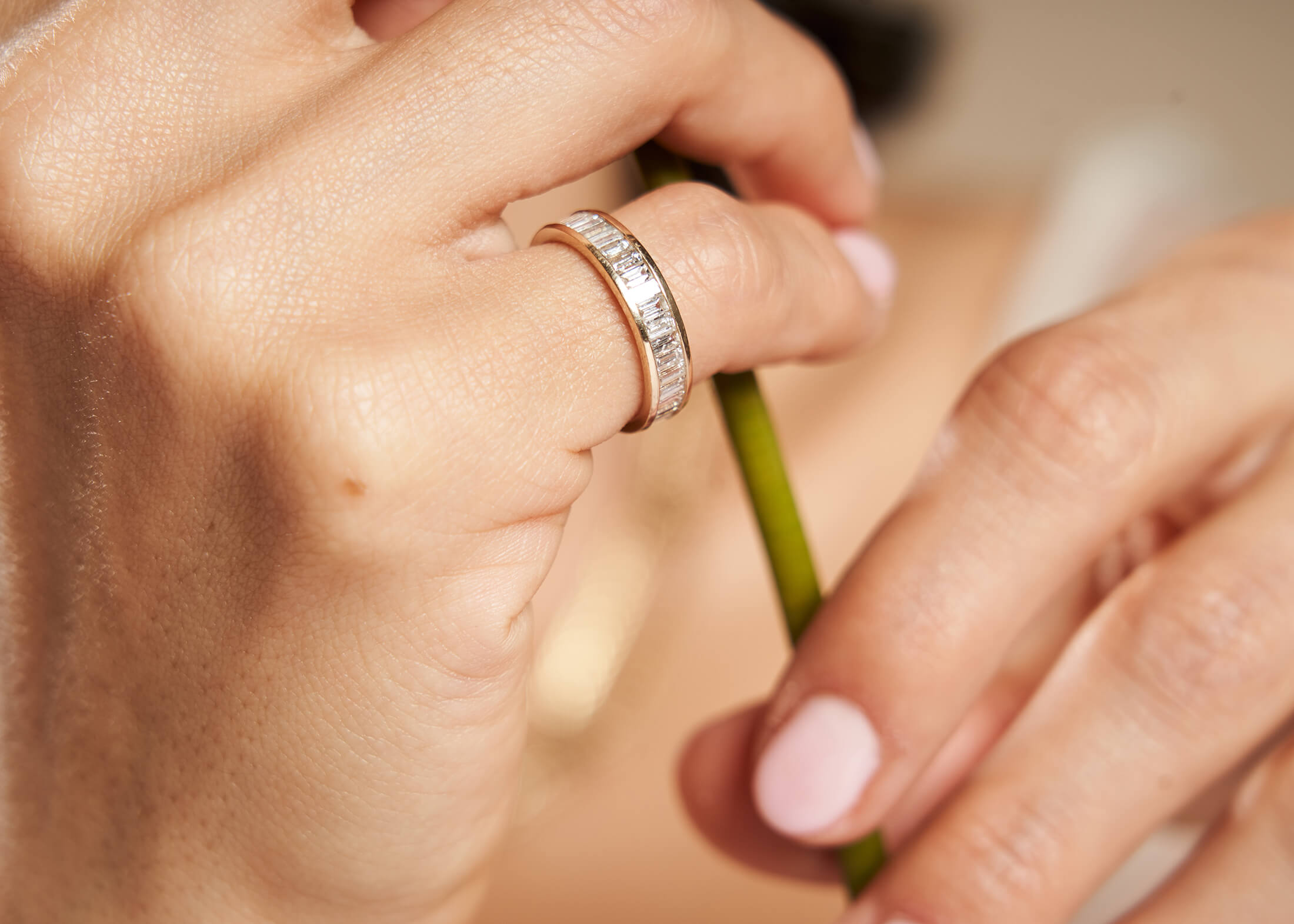 A North South Biggie Baguette Band on a woman's hand