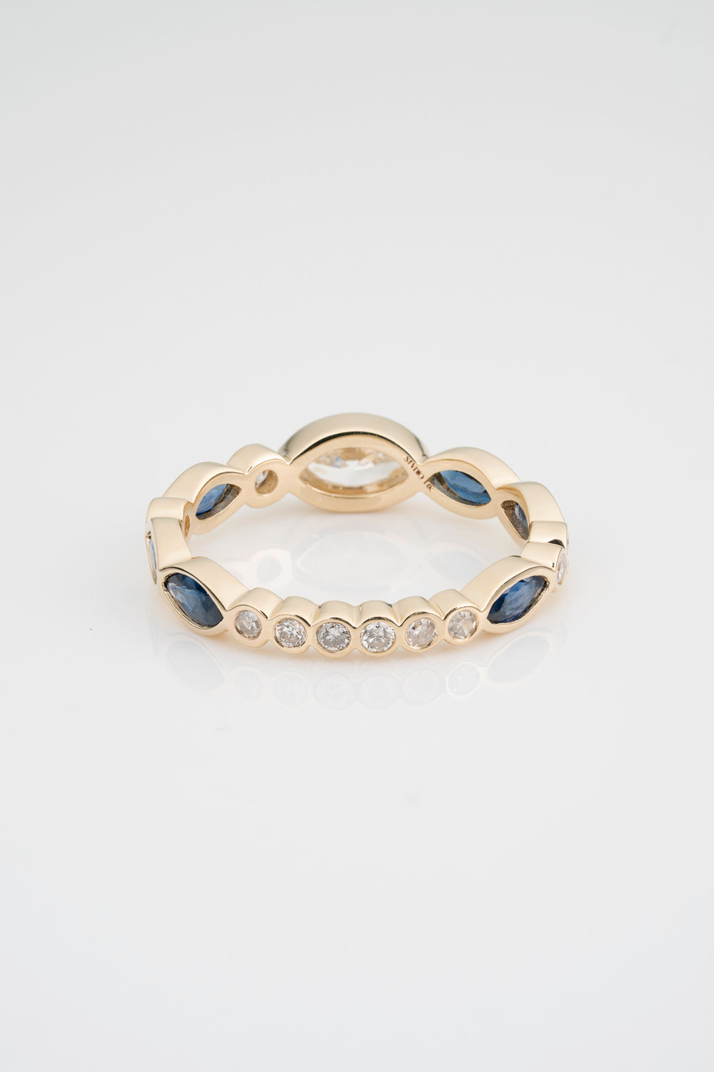 Custom Diamond and Sapphire Eternity Band sprinkled with White Diamond Marquise, Blue Sapphires, and Round White Diamonds. Stones are fully bezel set in 14k Yellow Gold