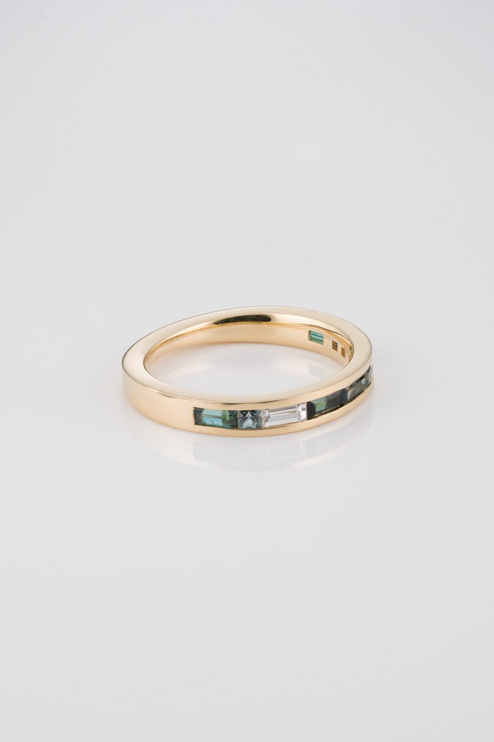 Channel Set 1/2 Eternity Mosaic Band with White Diamond Baguettes, Green Australian Sapphire Baguettes, and Green Australian Princess Cut Baguettes. 