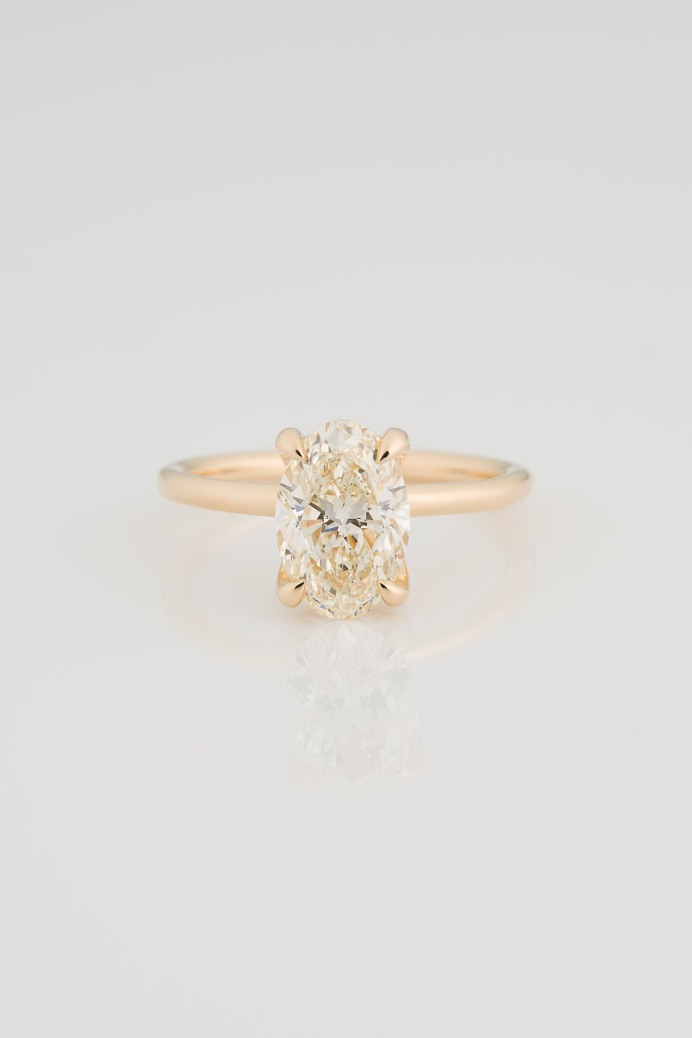 Oval Diamond Solitaire with a Sculptural Setting, Pointed Prongs, and unexpected Diamond Detail on the setting. 