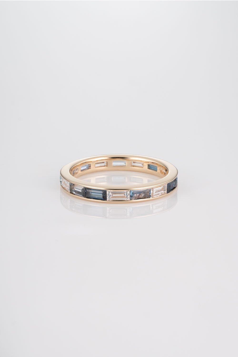 Channel Set Wedding Band with Australian Blue Sapphires, Yogo Sapphires, Light Montana Sapphires, and White Diamonds. 