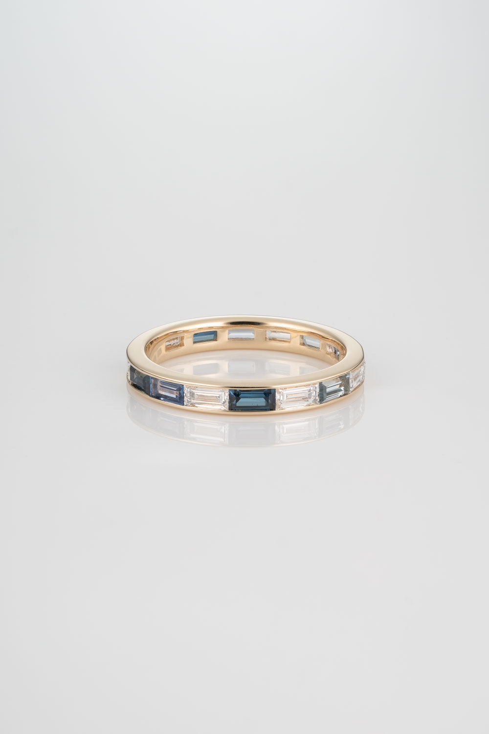 Channel Set Wedding Band with Australian Blue Sapphires, Yogo Sapphires, Light Montana Sapphires, and White Diamonds. 