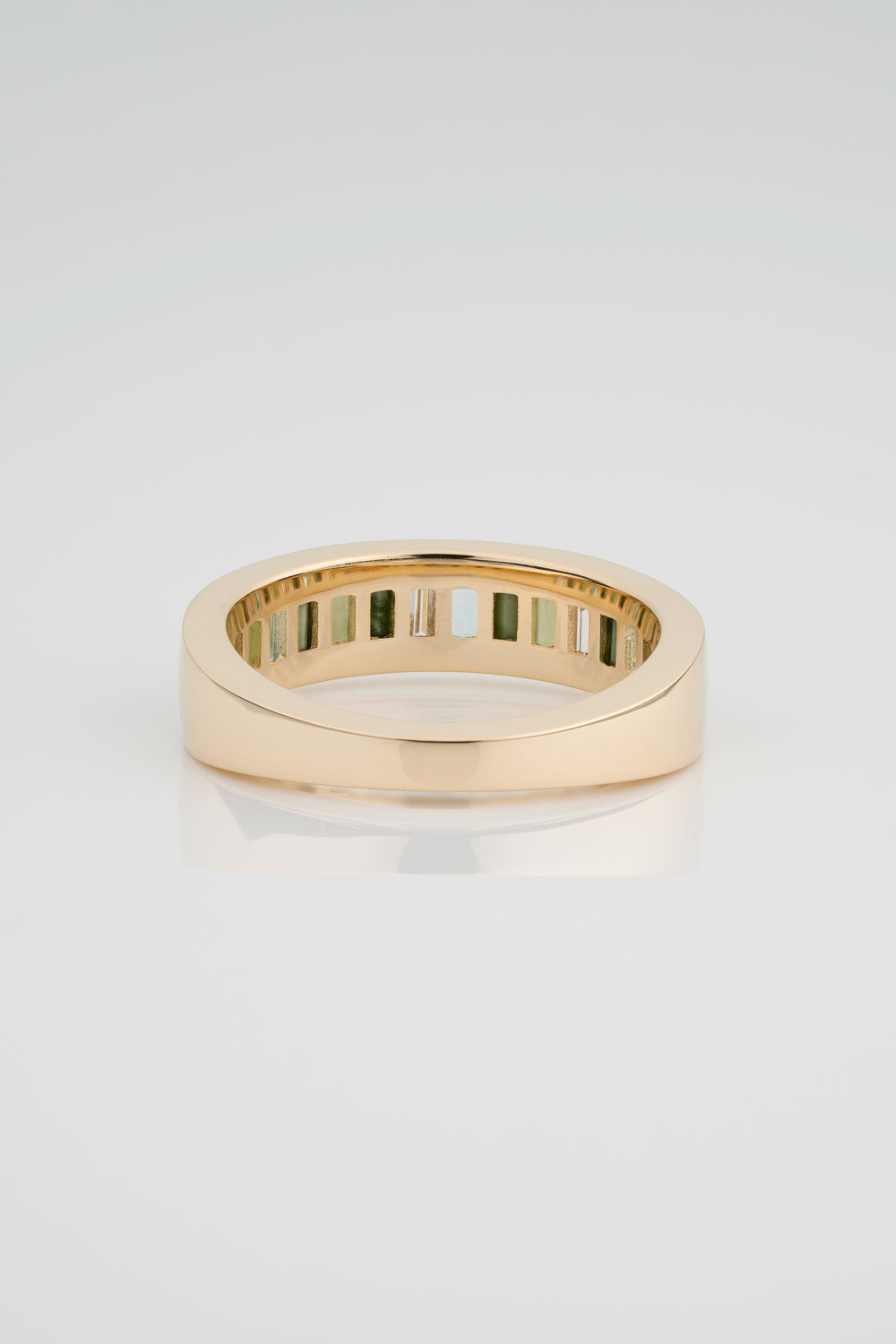 Custom Channel Set Band with North South Facing Baguettes made from Jasper, Jade, Green Beryl, and White Diamond. The back half of the band has a gold tapered backing. 